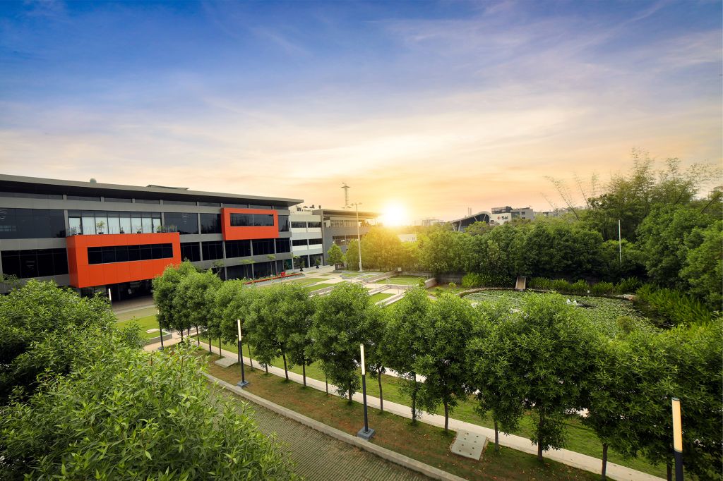 Sai Life Sciences' eco-friendly campus with green landscaping and modern architecture at sunset, featured in a blog post about the company's 2024 Sustainability Report